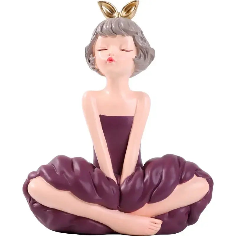 Pastel green bowknot fairy girl resin figurine with purple and gold accents sitting in a meditative pose for bedroom decor