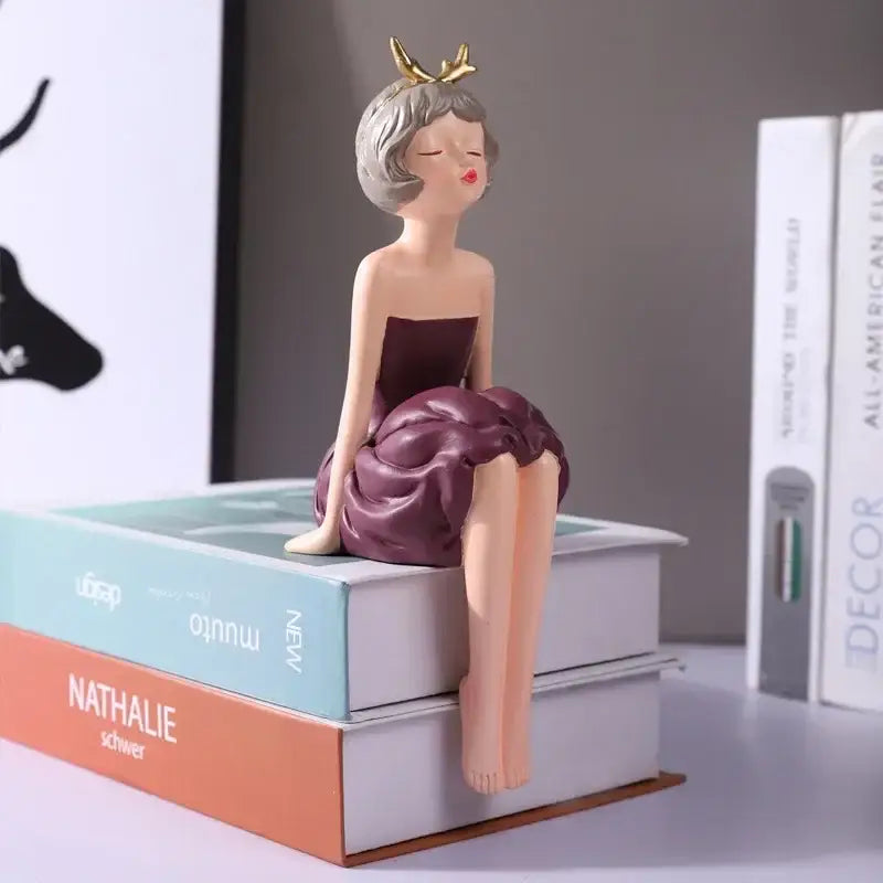 A resin bowknot fairy girl figurine with gray hair golden antlers and maroon dress for bedroom decor