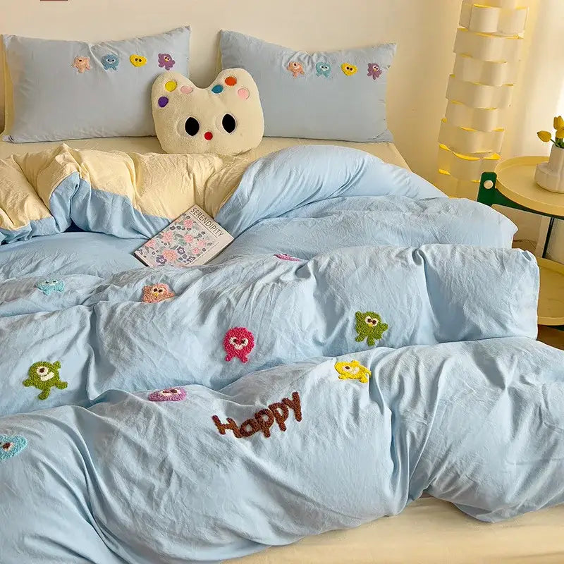 Pastel green quilted comforter with light blue decorbites cartoon embroidery and happy text in brown thread bedding set