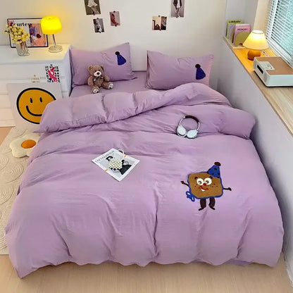 Lavender bedding set with decorbites cartoon towel embroidery featuring playful cookie character and blue party hat