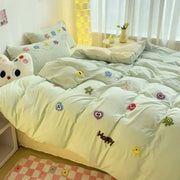 Pastel green quilted bedding set with colorful decorbites cartoon towel embroidery featuring happy faces