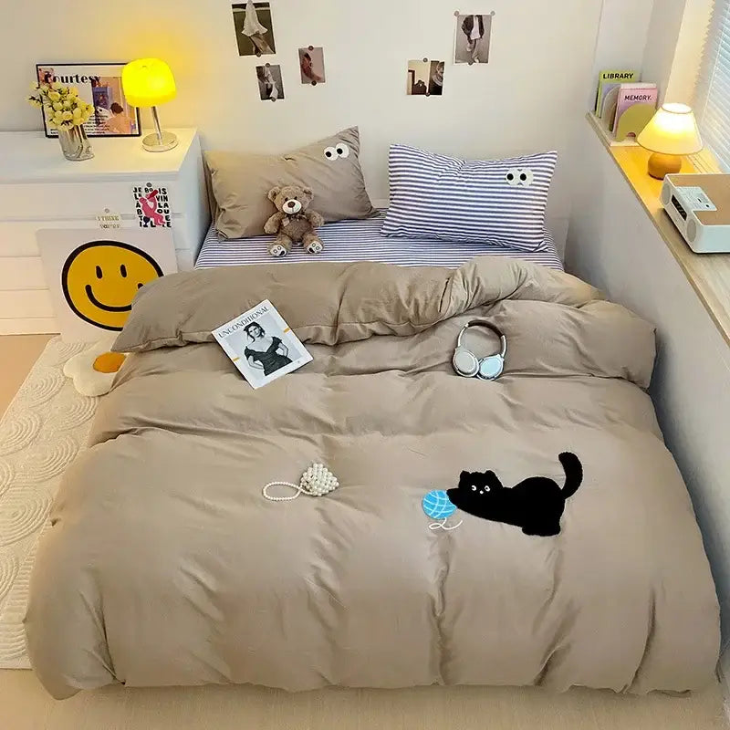 Beige quilted duvet cover with black cat and blue ball design in pastel green cartoon towel embroidery bedding set decorbites decor