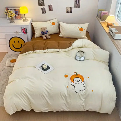 Cream-colored quilted bedding set with cartoon towel embroidery of a ghost wearing an orange pumpkin hat decorbites cartoon towel