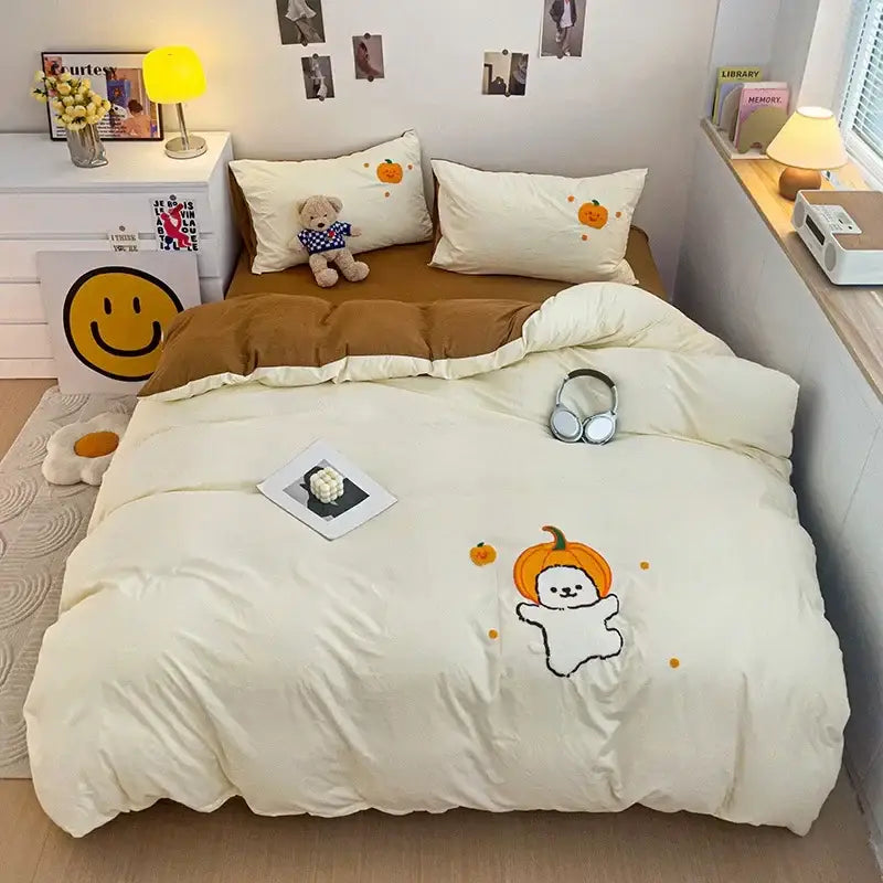 Cream-colored quilted bedding set with cartoon towel embroidery of a ghost wearing an orange pumpkin hat decorbites cartoon towel