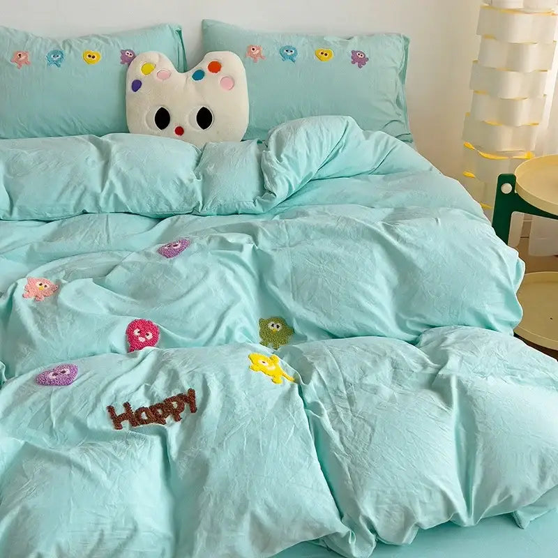 Pastel green cartoon towel embroidery bedding set features a mint green quilted comforter with colorful characters and happy decorbites cartoon towel design