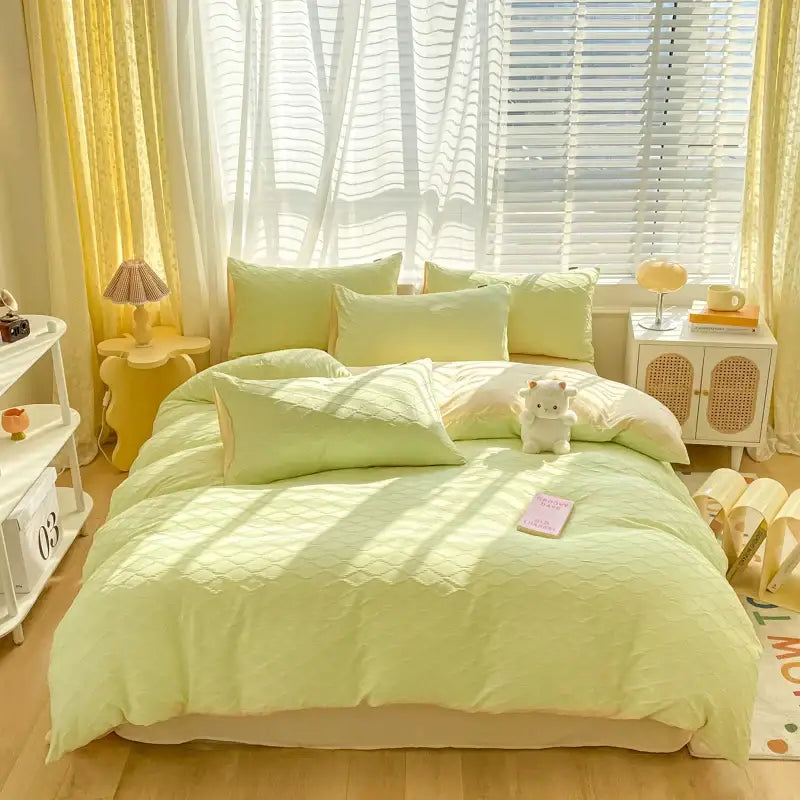 Linen-textured mint green quilted bedding set with fresh bubble yarn and plush white stuffed animal decorbites fresh bubble
