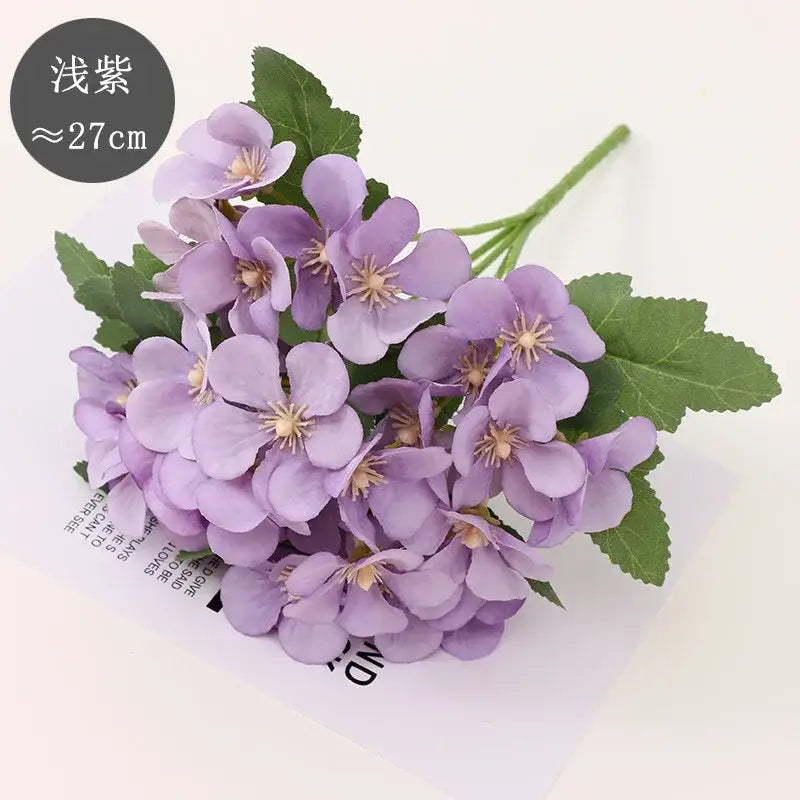 A delicate cluster of pastel light purple begonia flower dry artificial blooms with green stems for living room decor