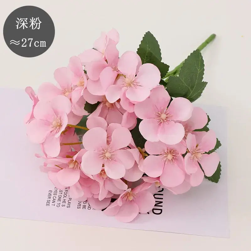 A cluster of deep pink artificial begonia flower dry hydrangea flowers with green leaves for dry flower embossing decor