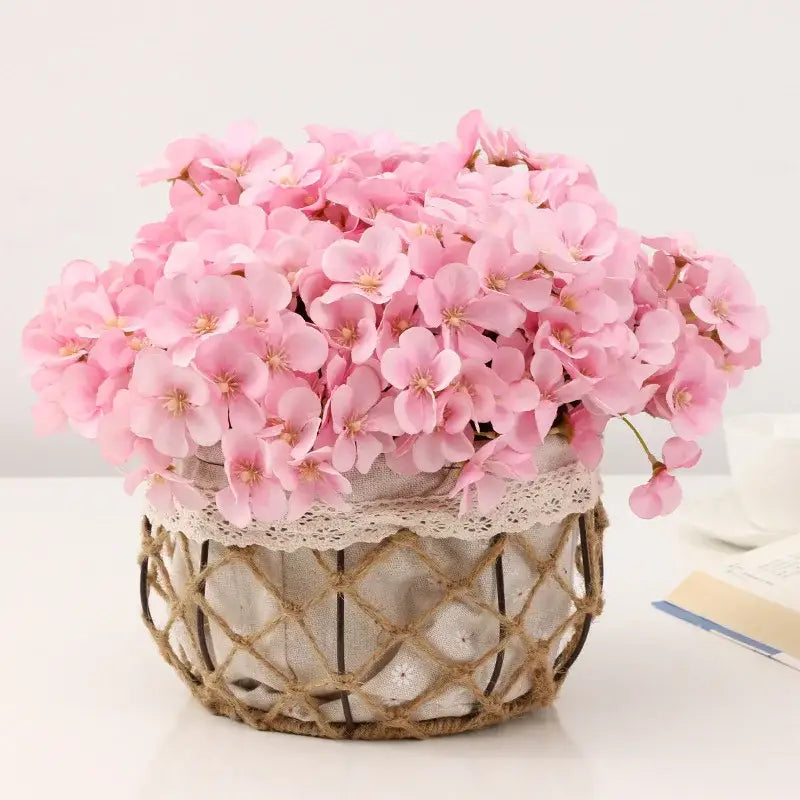 A pastel pink begonia flower dry arrangement with dry flower embossing in a wicker basket for living room decor