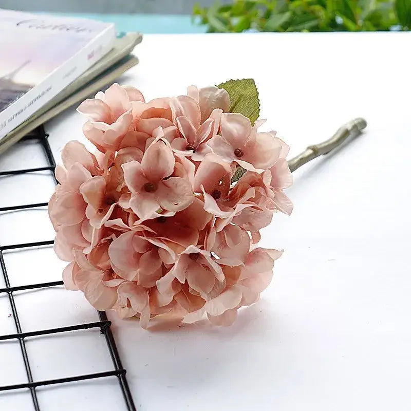 A delicate pink pastel hydrangea branch silk flower bouquet with layered petals and green stem for decorbites hydrangea branch decor