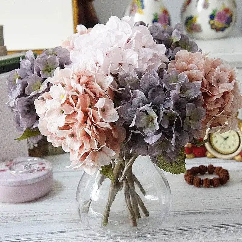 Pastel hydrangea branch silk flower bouquet in soft pink lavender and white displayed in clear glass vase for dining decorbites hydrangea branch decor