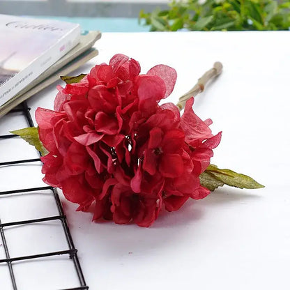 Vibrant red decorbites hydrangea branch silk flower bouquet with layered petals and green leaves for dining room decor