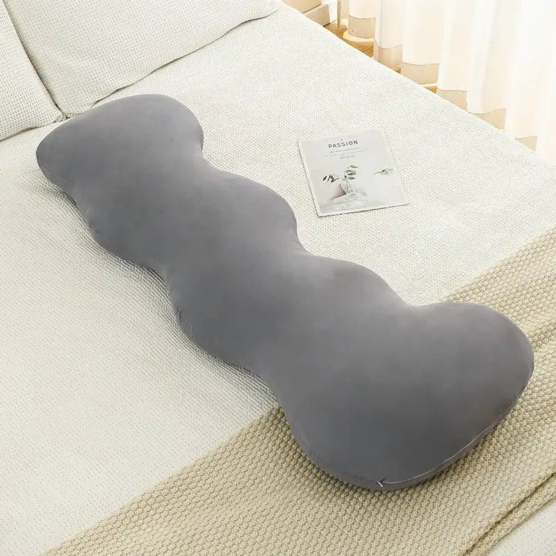 A plush gray ice cream wavy pillow with soft velour texture on a textured bedspread for decorbites ice cream decor