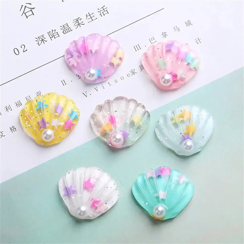 Pastel-colored iridescent resin pearl shells beach decor charms with glittery stars and central pearl embellishments