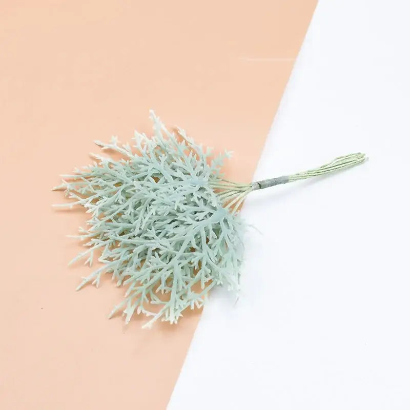 A delicate pale green artificial plant with feathery foliage and bundled stem from decorbites 10pcs artificial plants set