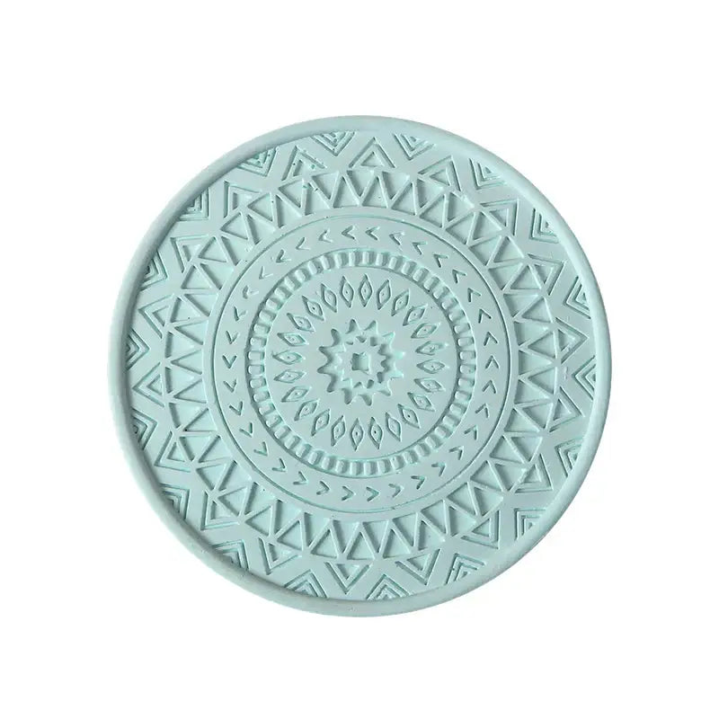 A circular mint green pastel mandala decorbites diatomite round coaster with an embossed geometric design for drink mats