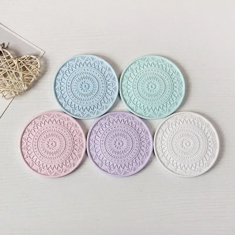 Set of five pastel-colored decorbites diatomite round coasters with intricate mandala patterns for dining room use