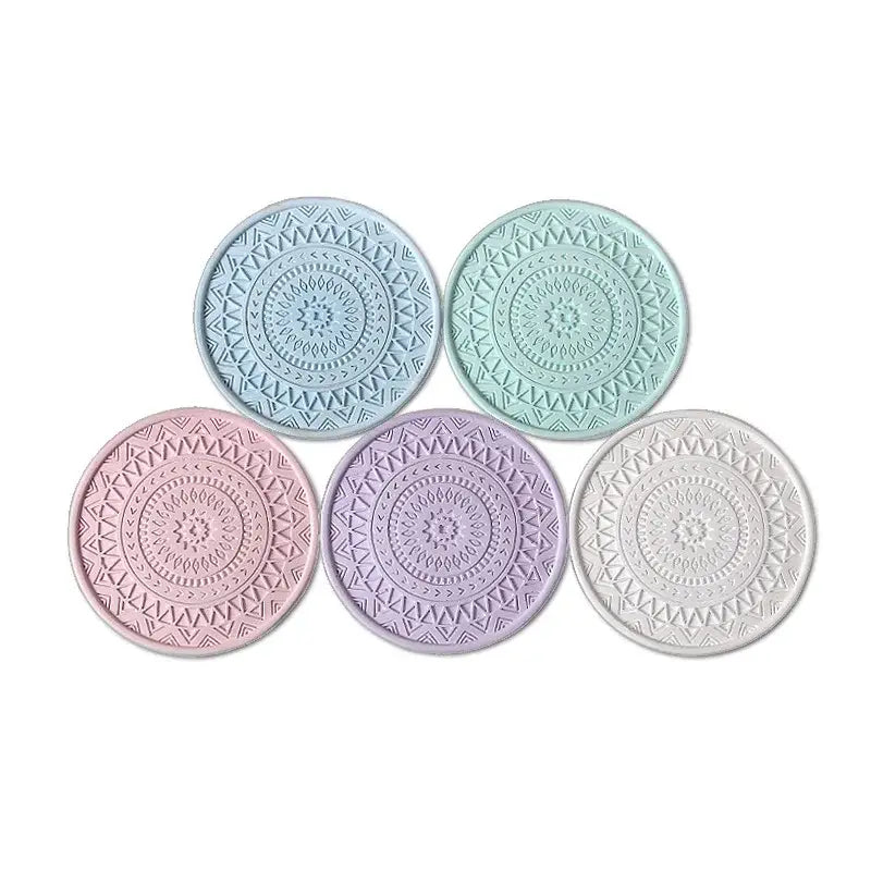 Set of five pastel-colored decorbites diatomite round coasters with intricate embossed mandala patterns for dining room use