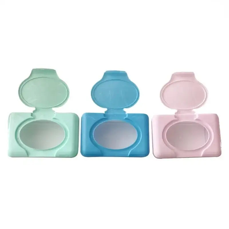 Three pastel-colored plastic baby wet wipes dispensers in mint green blue and pink for bathroom use
