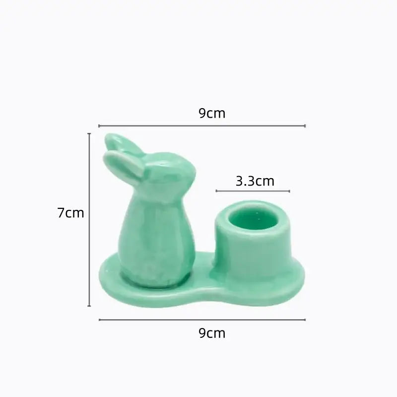 A mint green bunny rabbit ceramic candle holder with integrated cup base for dining room decor