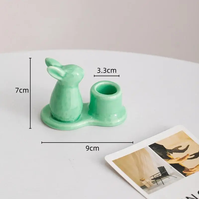 Pastel mint green bunny rabbit ceramic candle holder with glossy finish and integrated cylindrical cup for dining room use