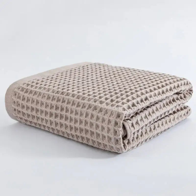 Folded beige decorbites cotton waffle bath towel with textured grid pattern from pastel multi color cotton waffle bath set