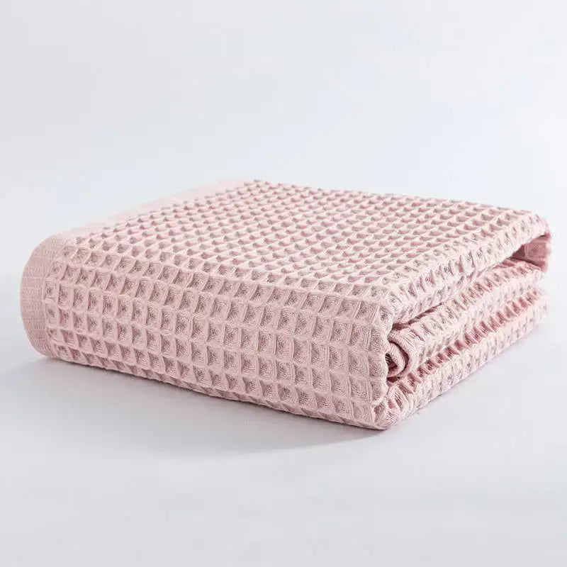 A soft pink cotton waffle bath towel with a textured grid pattern from the pastel multi color decorbites set