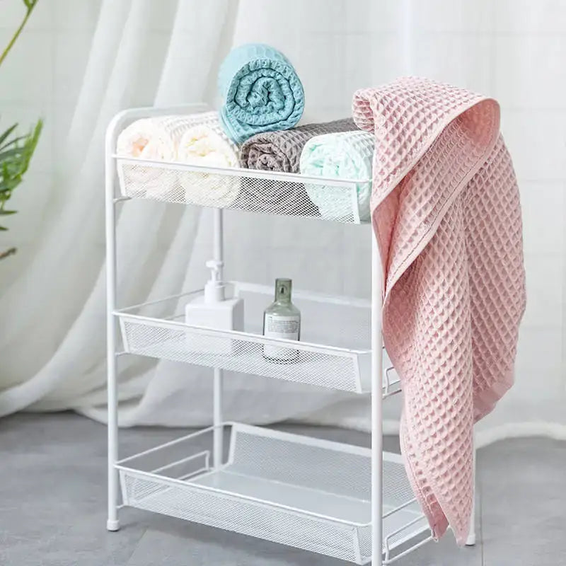 White metal mesh three-tier bathroom storage rack complementing pastel multi color decorbites cotton waffle bath towels