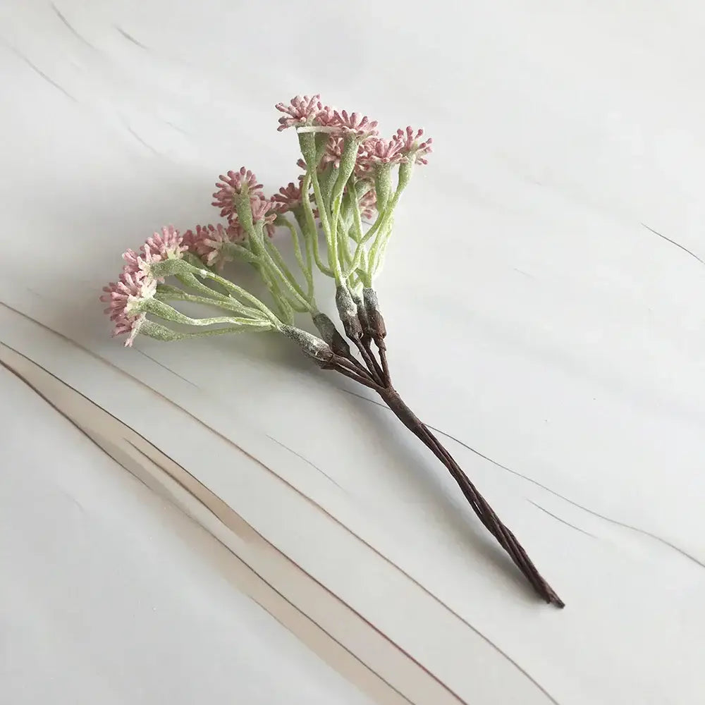 A pastel multi color decorbites decorative vase set with a delicate cluster of artificial pink and green frosty flowers
