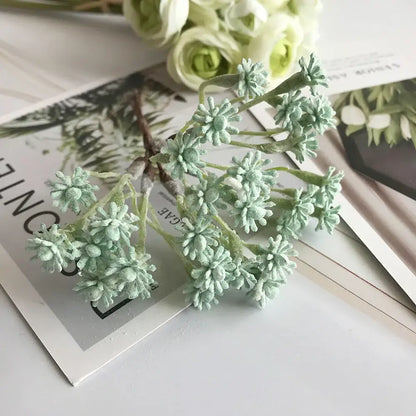 A pastel multi color decorative vase set featuring a delicate mint-green artificial floral decorbites decorative vase arrangement