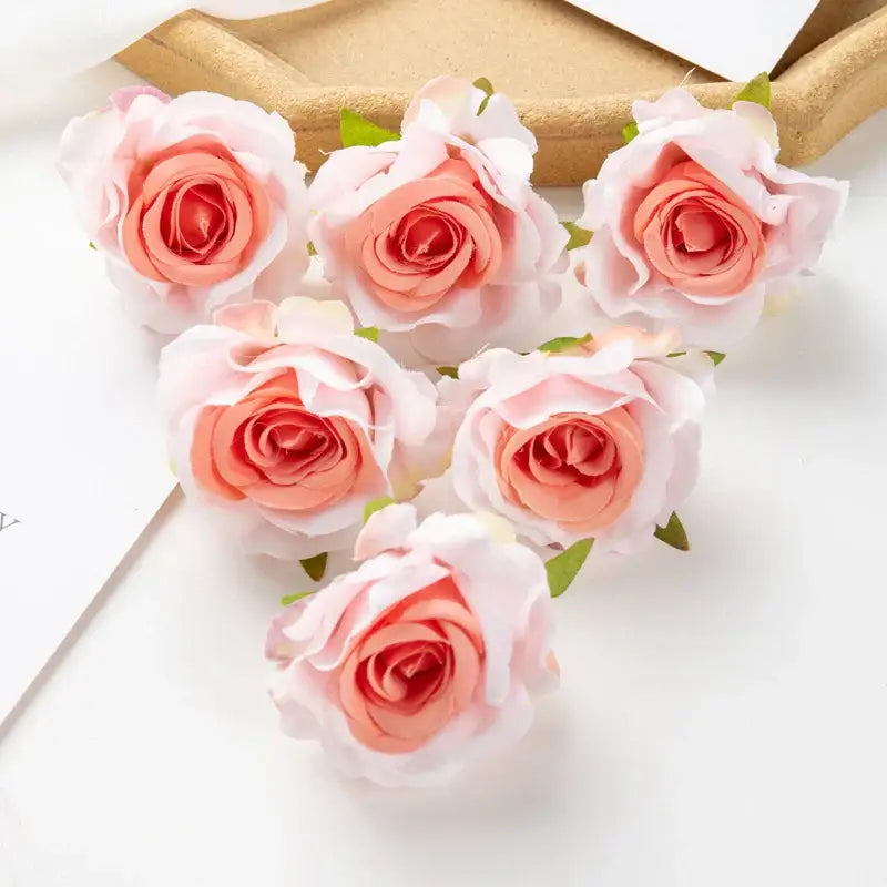 Six delicate peach and white artificial flowers with layered petals and green leaves from decorbites 100pcs multicolor silk set