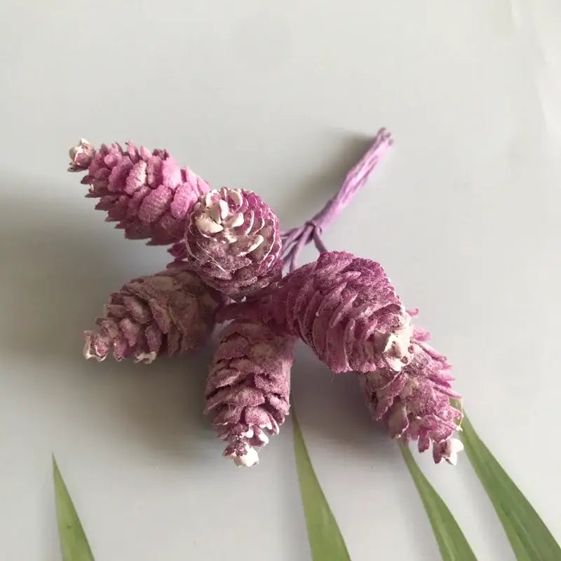 A pastel pinecone artificial flower wreath featuring dusty rose artificial flowers with white accents for living room decor