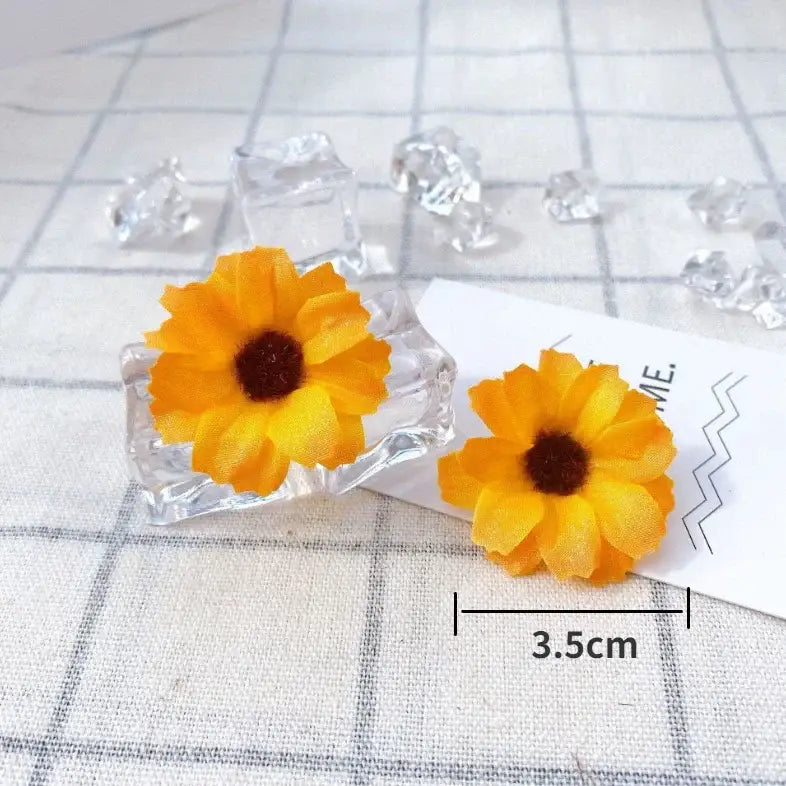 Vibrant yellow sunflower-shaped fabric earrings with dark brown centers in clear crystal holders for decorbites mini daisy decorbites mini daisy artificial flowers wedding decor