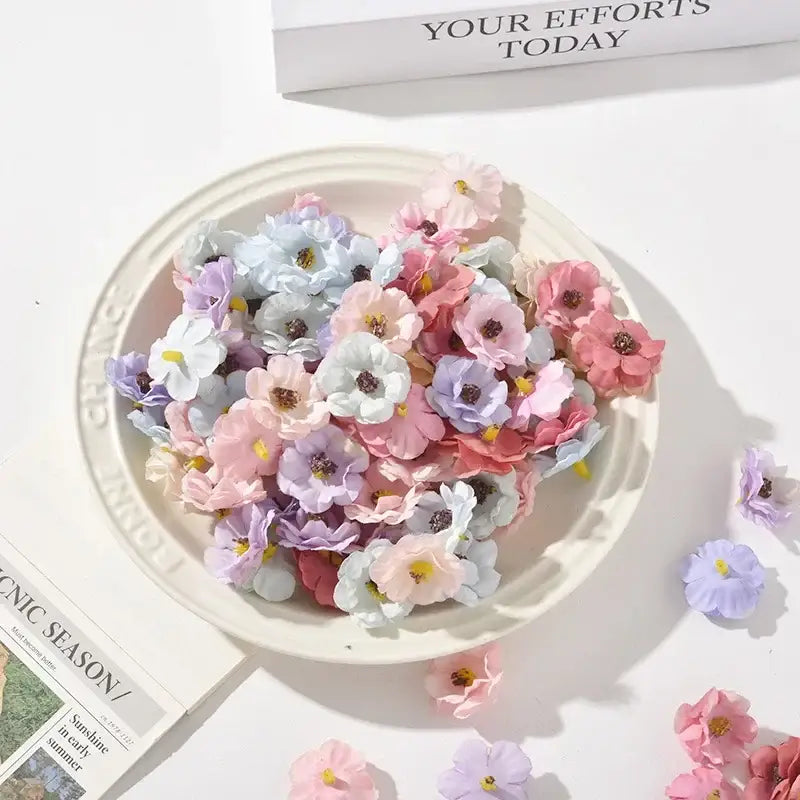 A bowl of pastel pink and lavender decorbites mini daisy artificial flowers for wedding decor in shades of pink lavender and light blue