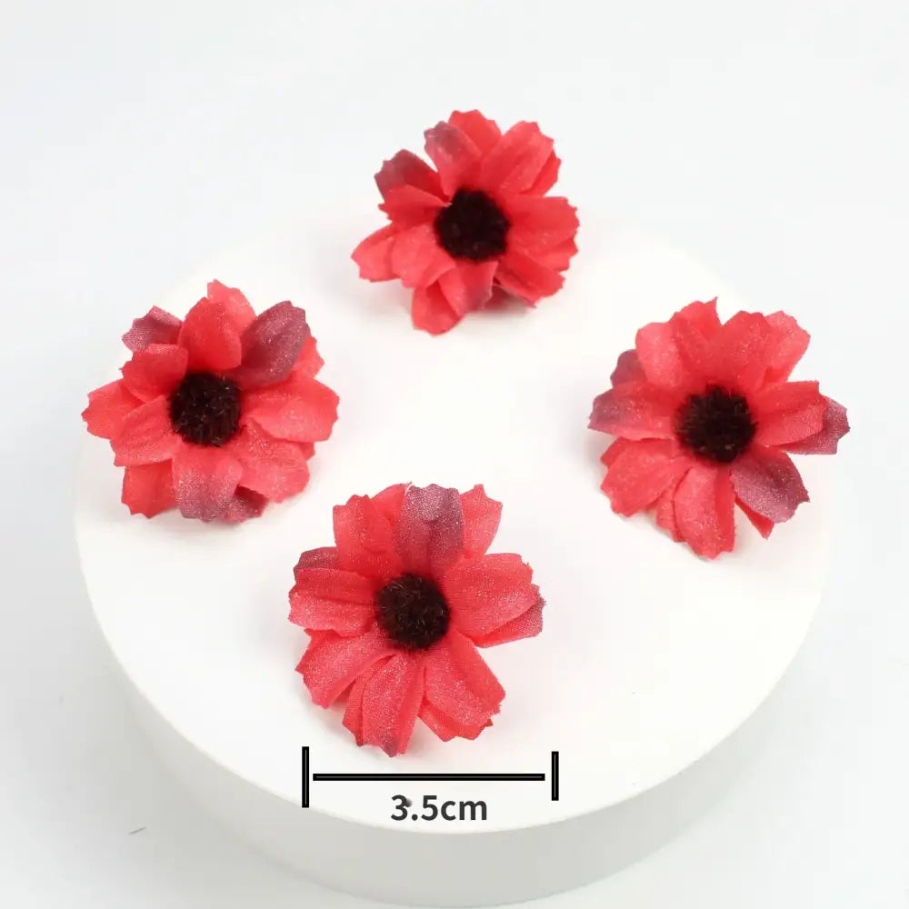 Four artificial red mini daisy flowers with dark centers and textured fabric material from decorbites mini daisy collection