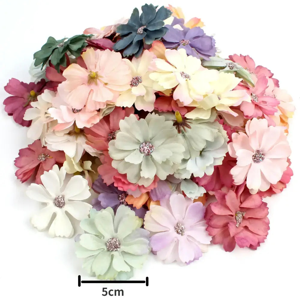 A collection of pastel pink and lavender decorbites mini daisy artificial flowers with rhinestone centers for wedding decor