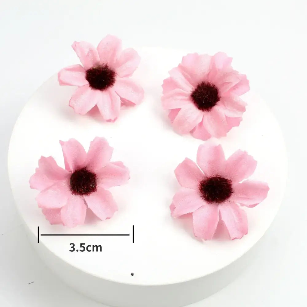 Pastel pink and lavender decorbites mini daisy artificial flowers with dark brown centers made from soft fabric for wedding decor