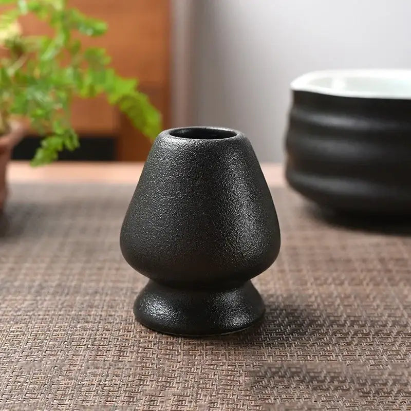 Black textured ceramic matcha whisk stand and tea bowl holder from pastel pink and yellow kitchen set