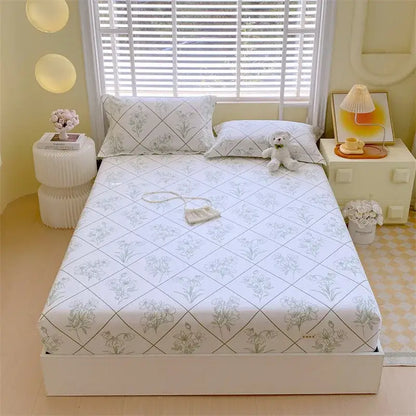 White bedsheet with delicate gray and green floral pattern and diamond lines paired with pastel pink blue cotton striped fitted sheet decorbites cotton striped bedding