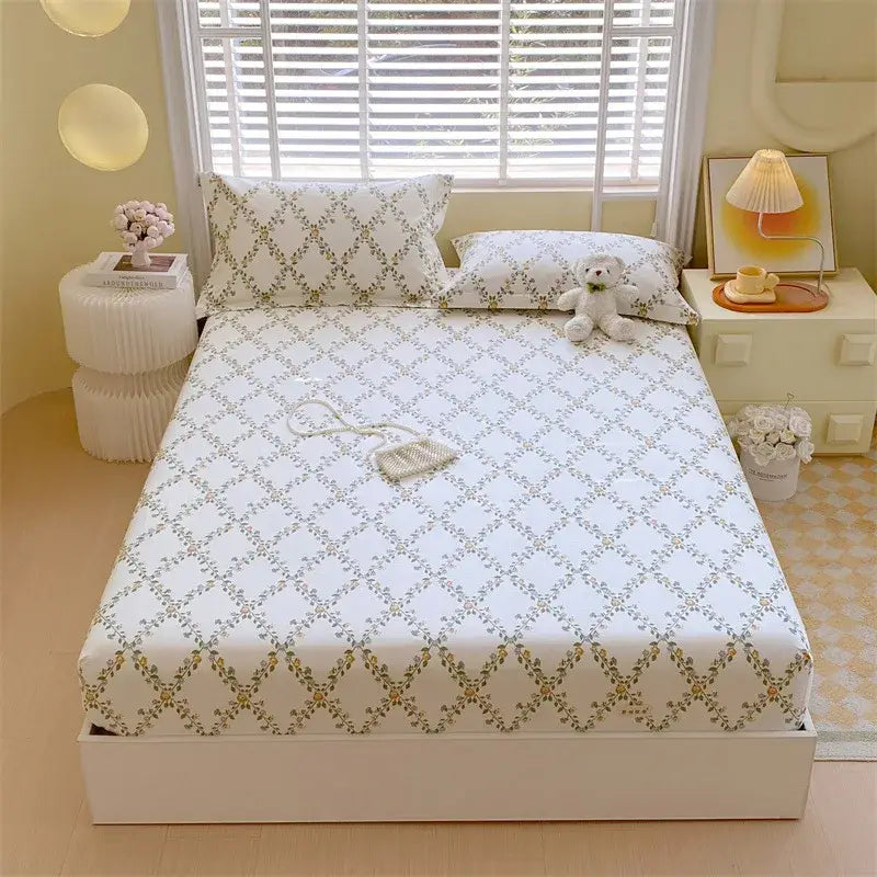 Pastel pink and blue cotton striped fitted sheet with white bed sheet featuring sage green and gold diamond lattice pattern