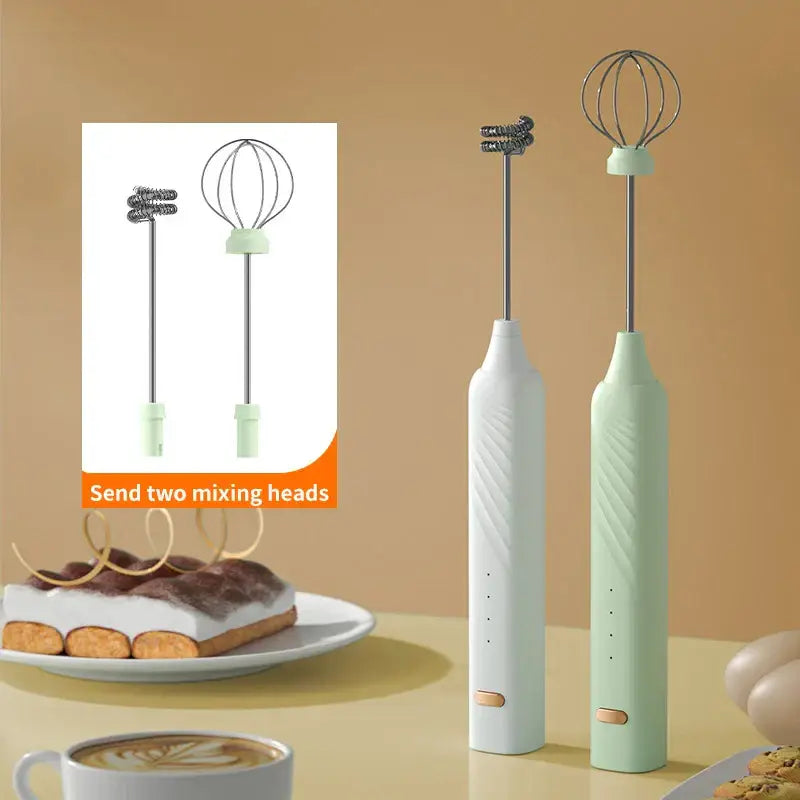Two sleek pastel pink and blue electric milk frothers with textured bodies and metallic mixing heads for coffee mixing