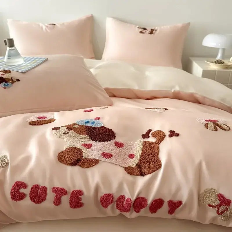 Pastel pink cotton bedding set with decorbites cartoon embroidery featuring a plush puppy in blue hat and red hearts