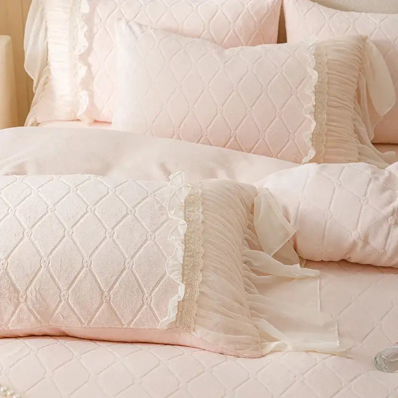 Pastel pink quilted pillow sham with delicate lace trim and ruffled edges from decorbites cozy velvet lace bedding set