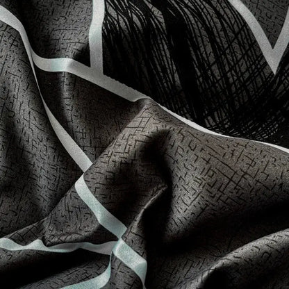 Black silk scarf with subtle geometric pattern and bold white stripes complementing decorbites cozy cotton bedding set