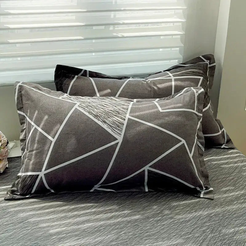 Gray pillowcases with modern white geometric lines and textured triangles from pastel pink and cream decorbites cozy cotton bedding set