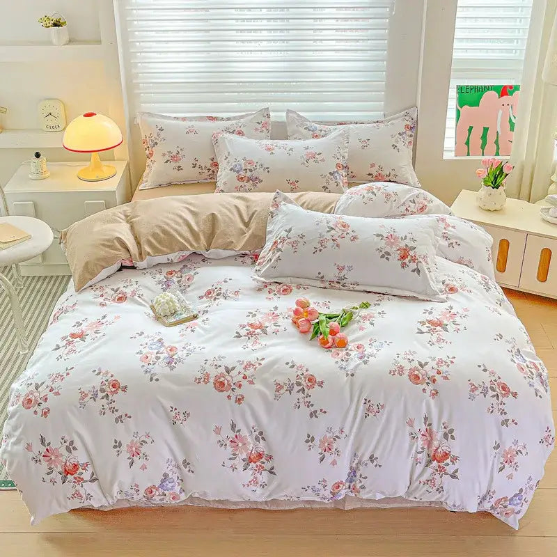 A soft white duvet cover with a pastel pink floral pattern from the decorbites cozy cotton bedding set