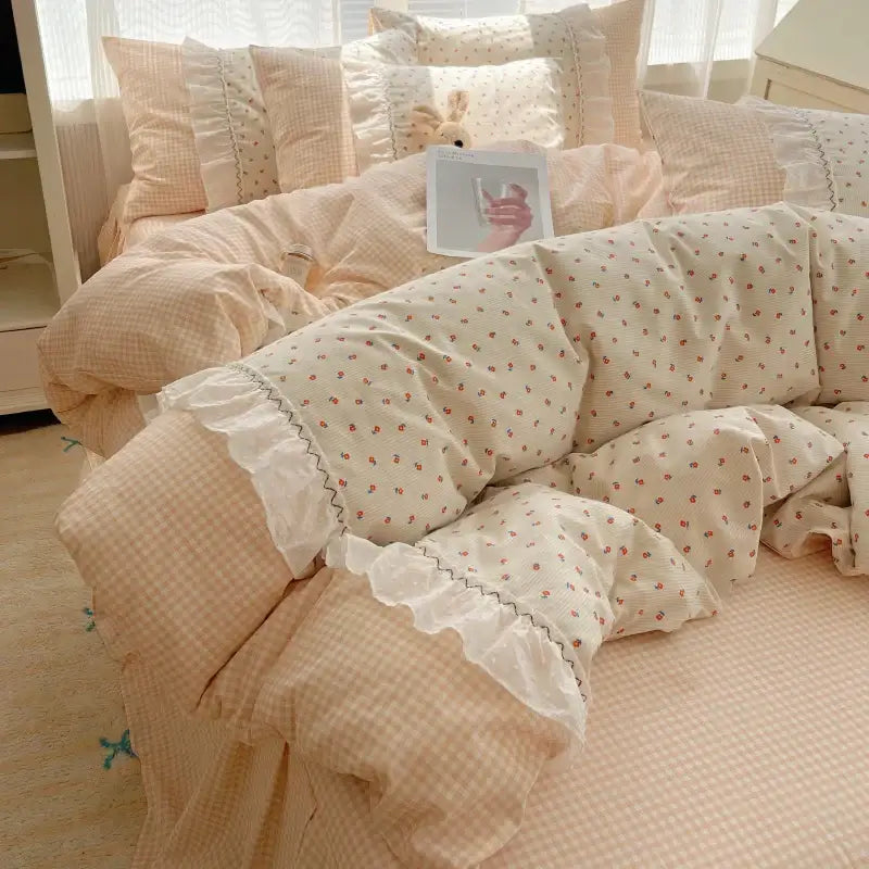 Cream-colored quilted bedding set with delicate red florals and white lace trim from decorbites cotton small florals collection