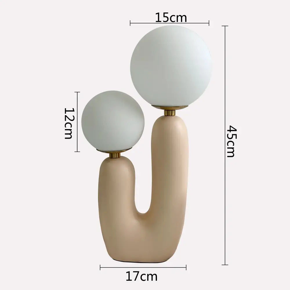 Cream-colored ceramic ball table lamp with dual frosted glass ball shades and gold-toned metal accents for bedroom use