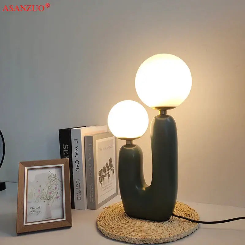 Modern green ceramic ball table lamp with dual glowing spherical glass ball shades for bedroom use