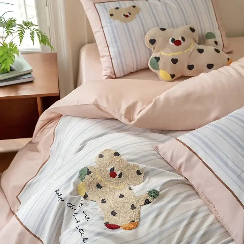 Pastel pink and gray decorbites cotton embroidered bedding set featuring a cute beige teddy bear appliqué with black spots